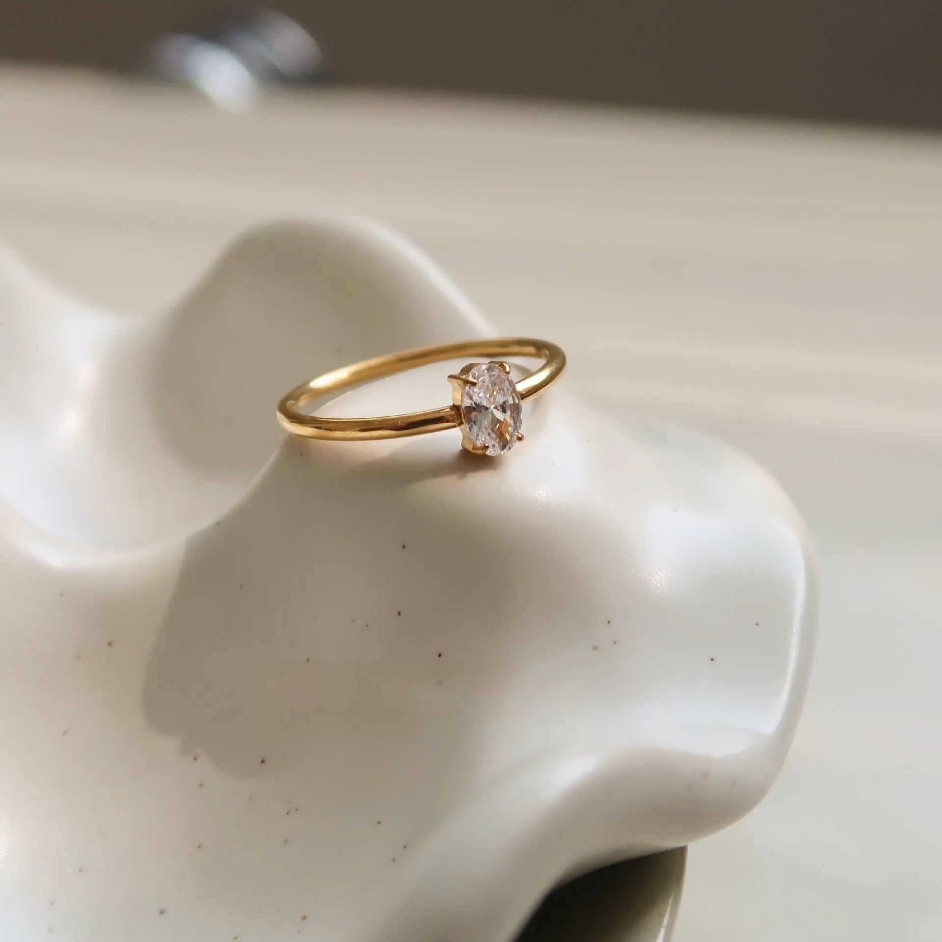 Simple golden stainless steel ring with either love heart or oval shape design in sizes 5 to 8