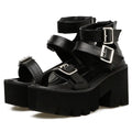 Black women's punk-style Roman sandals with a chunky platform heel and a back zipper closure.