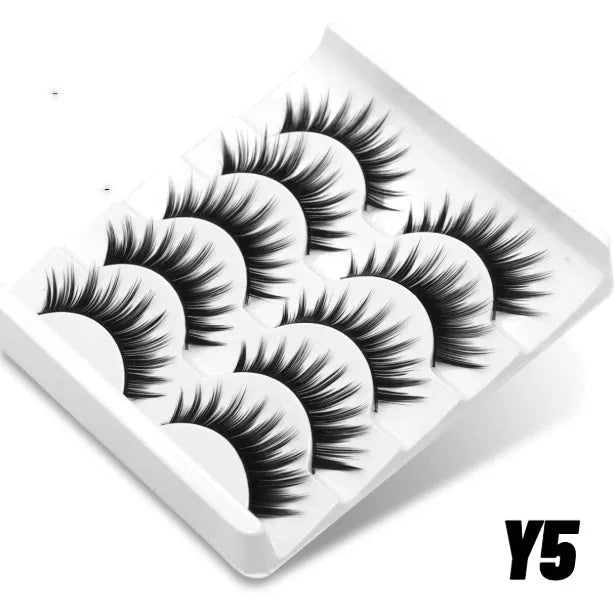 Box of artificial fibre false eyelashes in a natural long thick style with a tube of adhesive glue