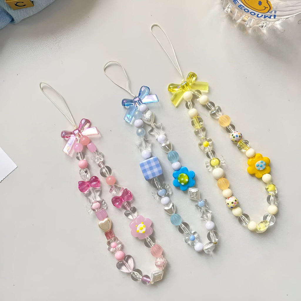 Beaded flower phone lanyard with floral charm on adjustable rope strap in blue, pink, or yellow