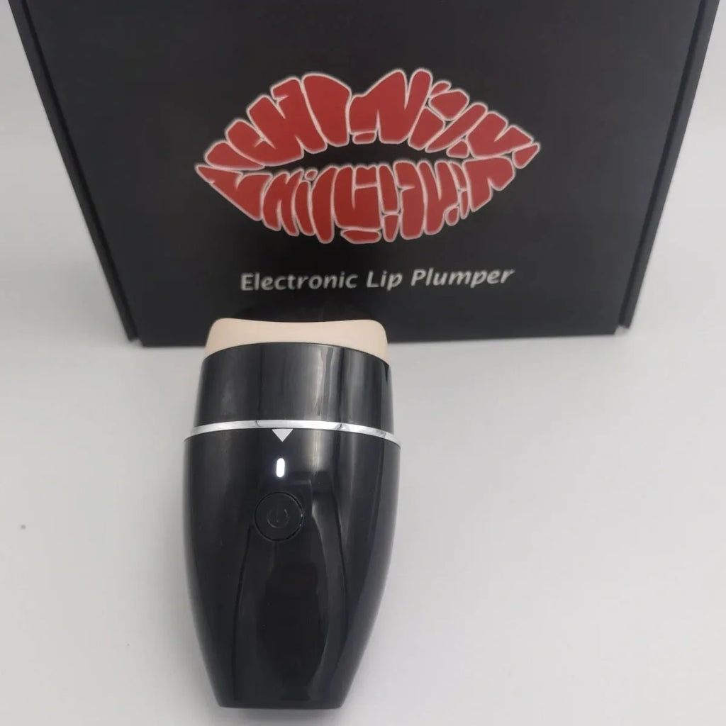 Black and white electric lip plumper device with silicone tip and USB charging cable