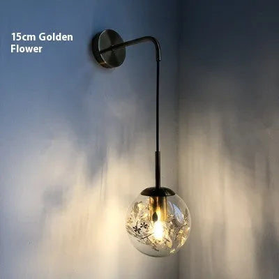 Modern glass wall-mounted bedside lamp in gold or silver finish, shown in 15cm and 20cm size options.