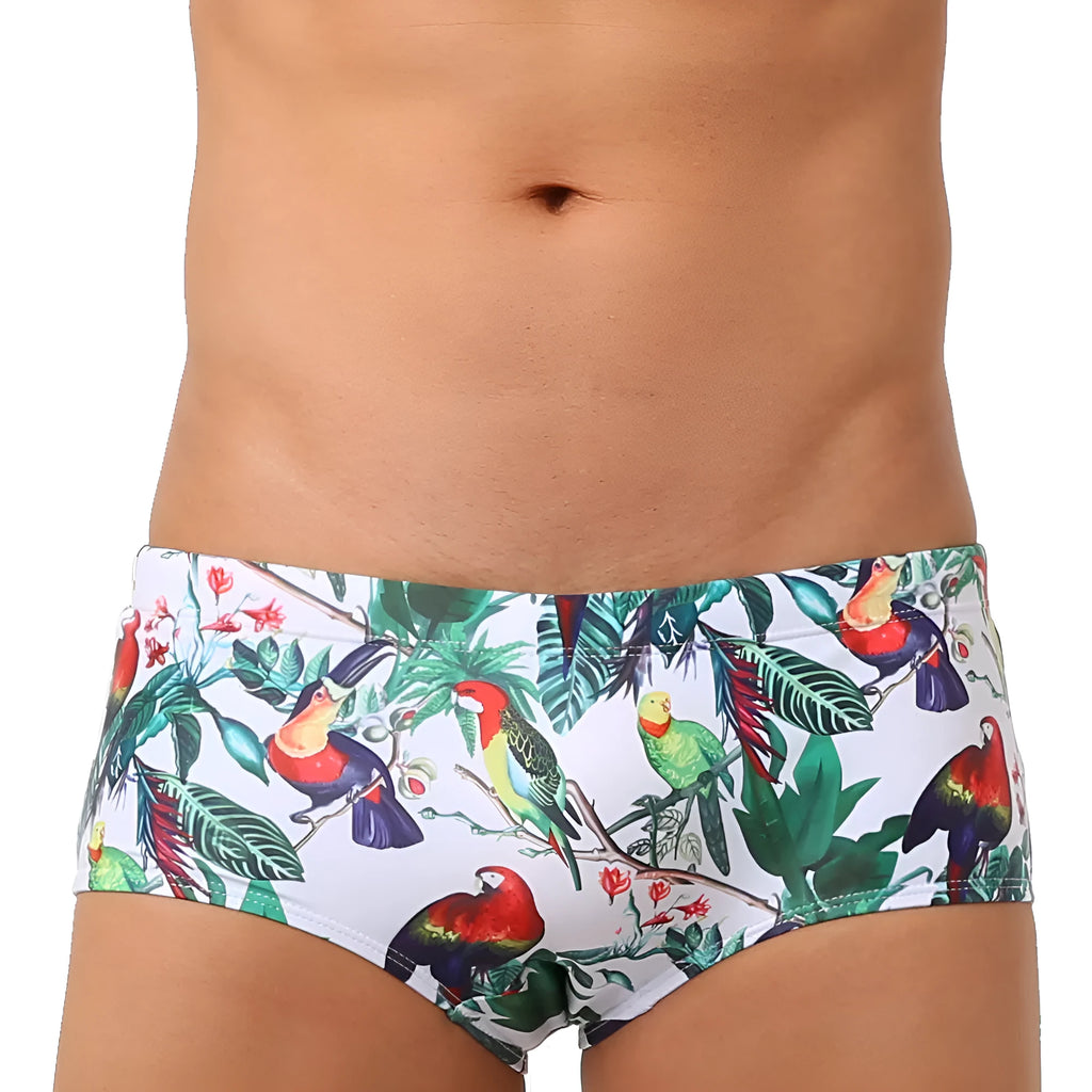 Men's blue swimming trunks with a colourful flowers and birds print, showing the boxer style and cup cover.