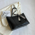 Women's soft bucket tote bag in multiple colours with crossbody strap and zippered internal compartment