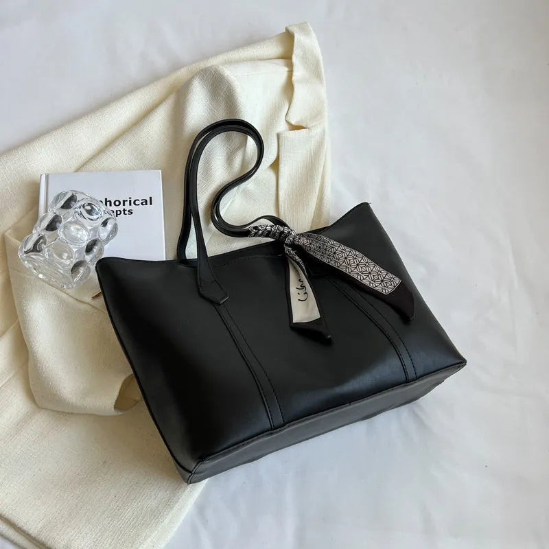 Women's soft bucket tote bag in multiple colours with crossbody strap and zippered internal compartment