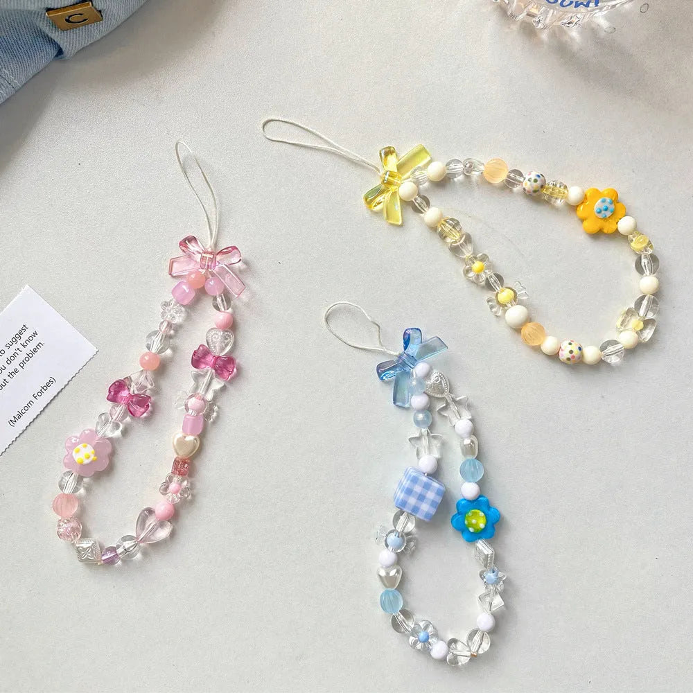 Beaded flower phone lanyard with floral charm on adjustable rope strap in blue, pink, or yellow