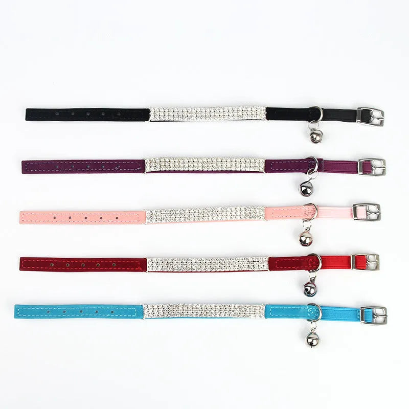 A soft red velvet cat collar with rhinestone decoration, showing the adjustable buckle.