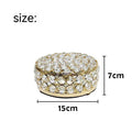 Transparent crystal glass jewelry storage box with ornate French gold metal frame.
