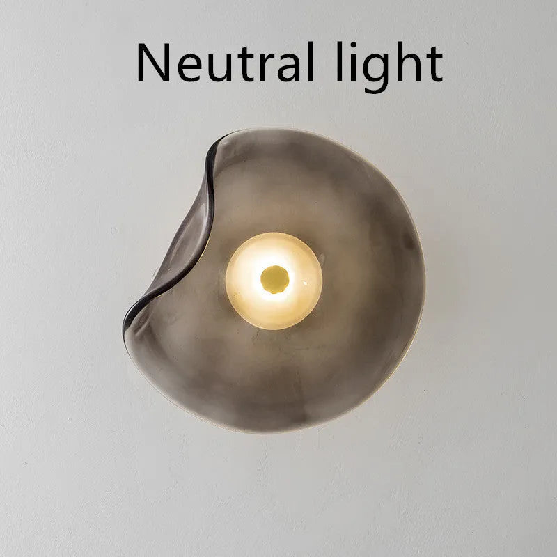 Round decorative wall lamp with glass shade in cognac colour for bedroom bedside lighting
