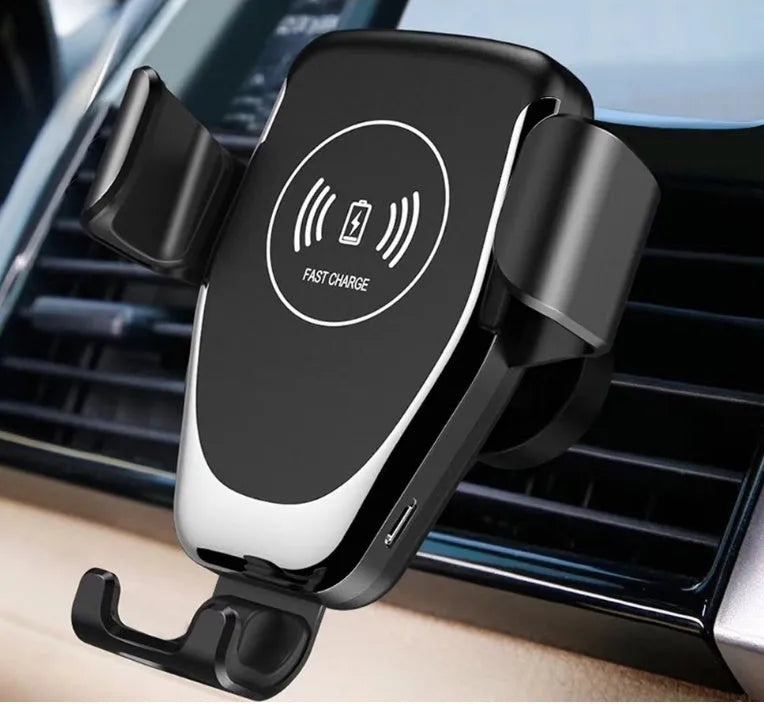 Black car wireless charger mount holding iPhone with automatic clamping arms on car vent