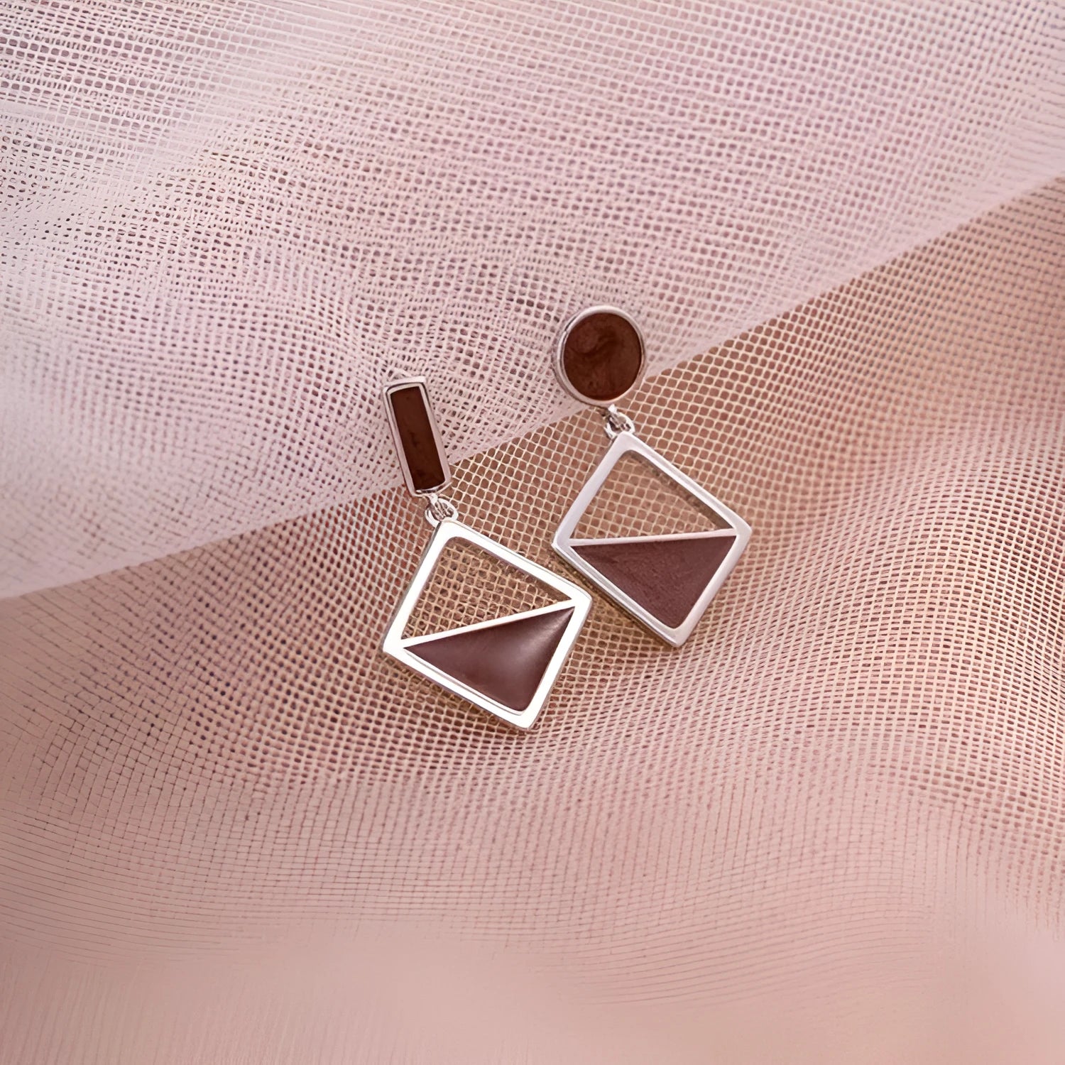 925 sterling silver asymmetrical stud earrings with frosty brown finish heart-shaped love motif on white background