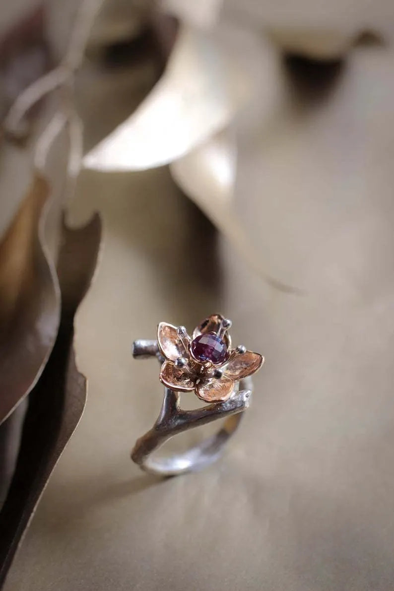 Silver two-tone floral design women's alloy ring on a geometric band.