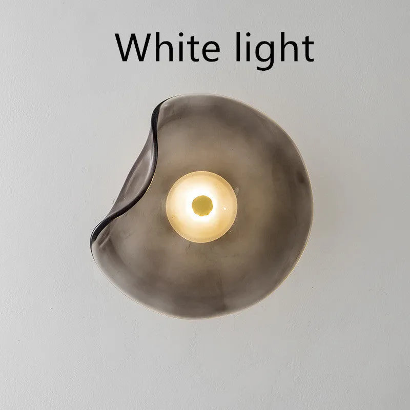 Round decorative wall lamp with glass shade in cognac colour for bedroom bedside lighting