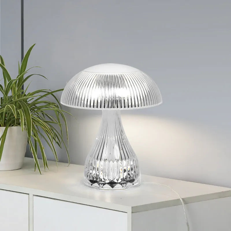 Small white rechargeable touch night lamp with three-colour changing light on wooden table