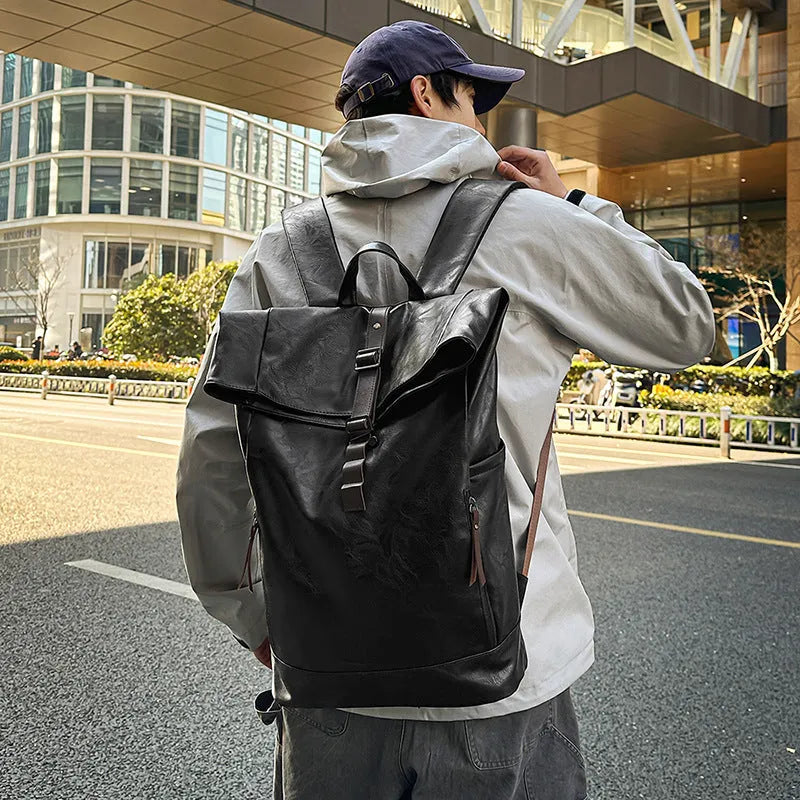 Large capacity PU leather backpack in black, solid colour, with curved shoulder straps and visible sewing line details
