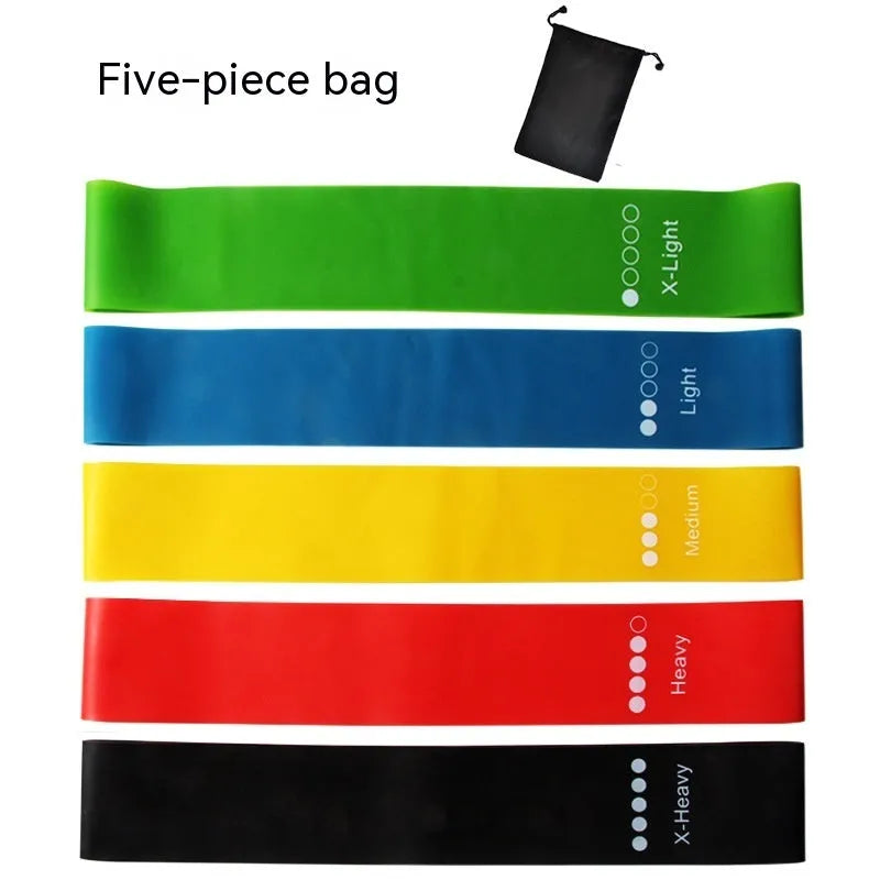 Set of five coloured TPE yoga tension resistance bands with force marks, laid flat showing different thicknesses.