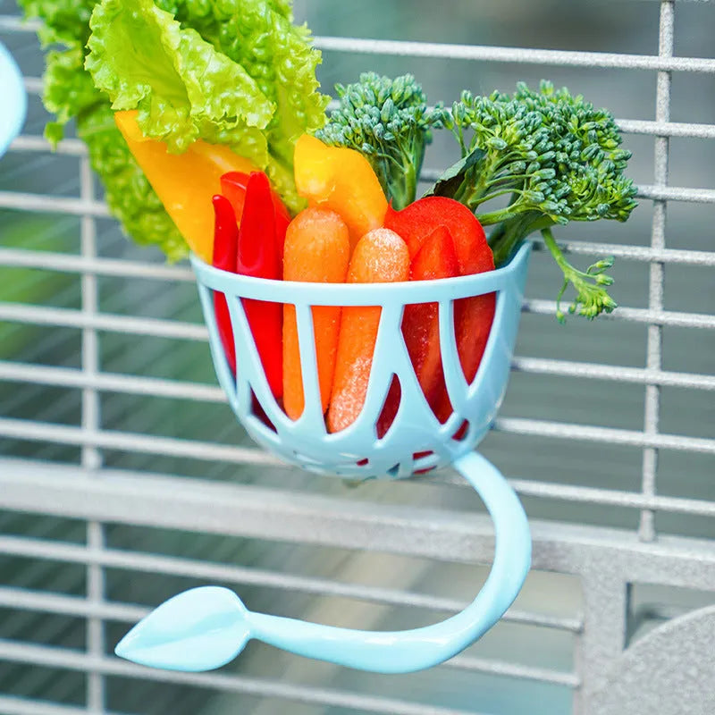 Plastic parrot fruit basket feeder with two vegetable clips for holding fresh produce in a cage or aviary