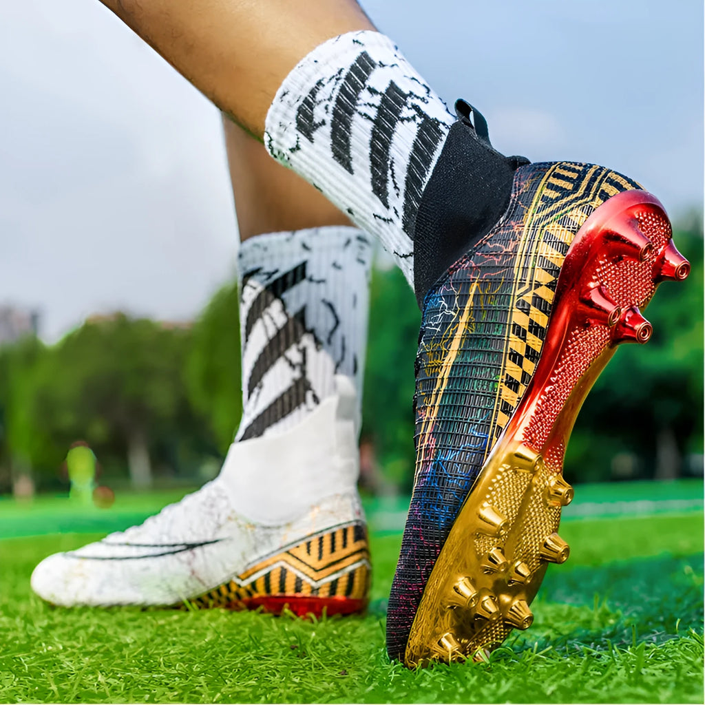 High-top soccer training shoes with gold bottom detail on artificial grass surface