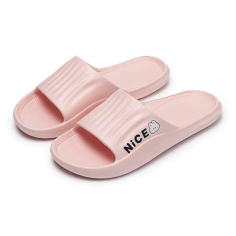 Pair of lightweight EVA flip-flop slippers with a minimalist cartoon pattern and non-slip soles.