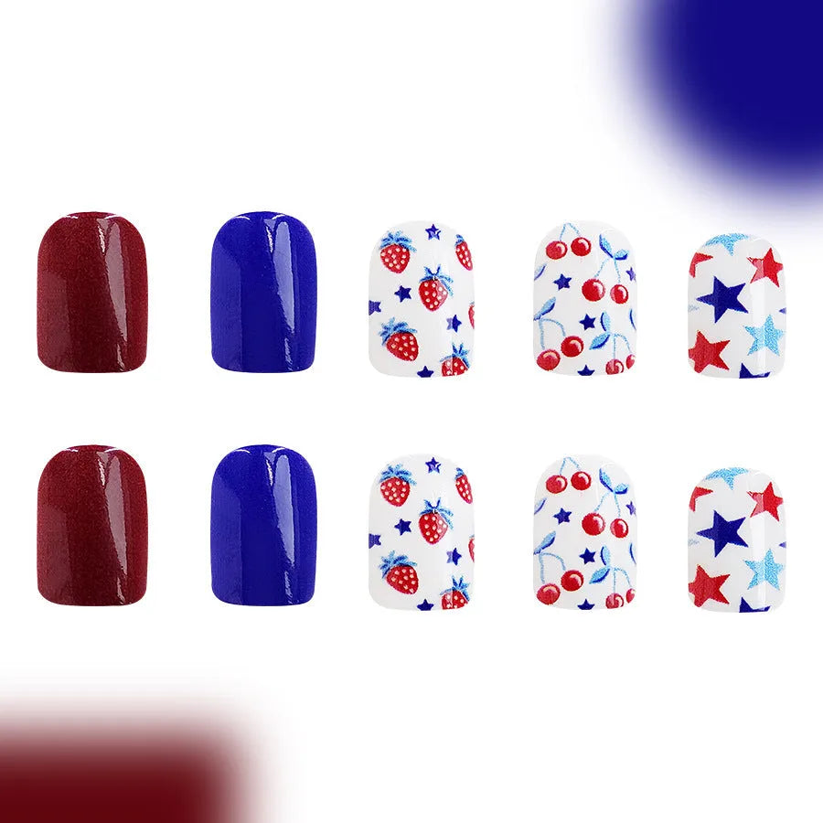 Short glossy false nails with strawberry cherry independence day pattern in red and blue colours