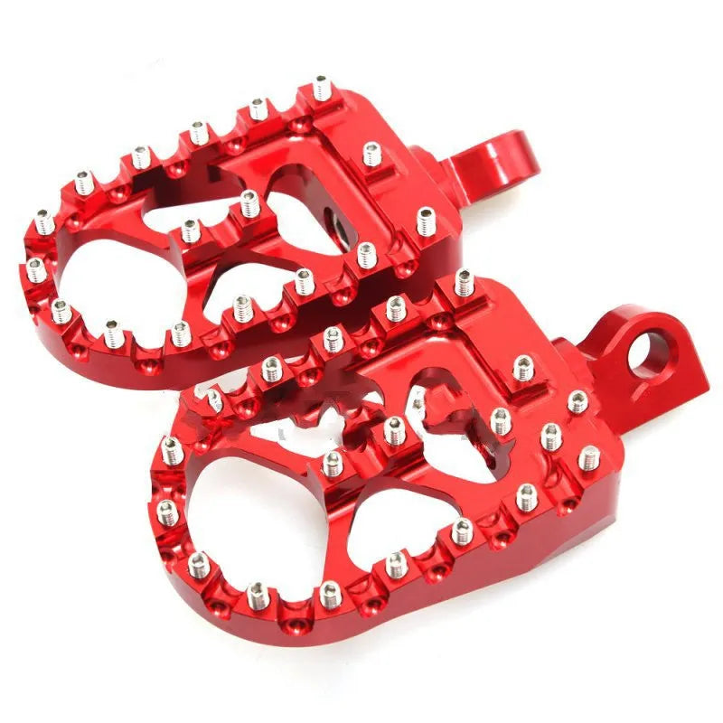 MX style wide foot pegs in red, black, or silver, 6061-T6 aluminium alloy with stainless steel teeth, 120mm x 57.5mm platform.