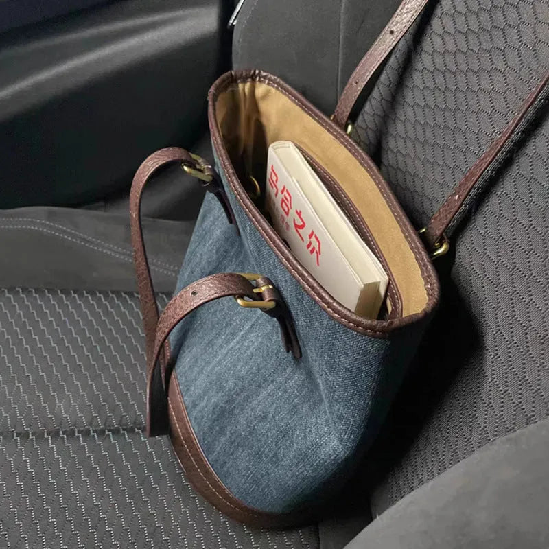 Denim patchwork polyester bucket handbag showing structured shape and one-shoulder strap