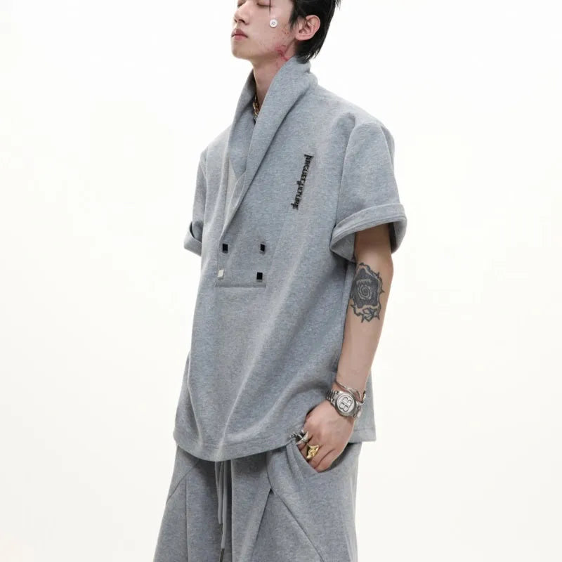 Men's dark grey V-neck padded shoulder sports suit with metal embellishments and matching shorts