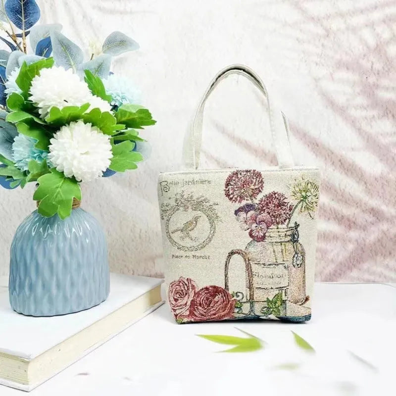 Double-sided embroidered canvas bag with gold wire detailing showing botanical pattern