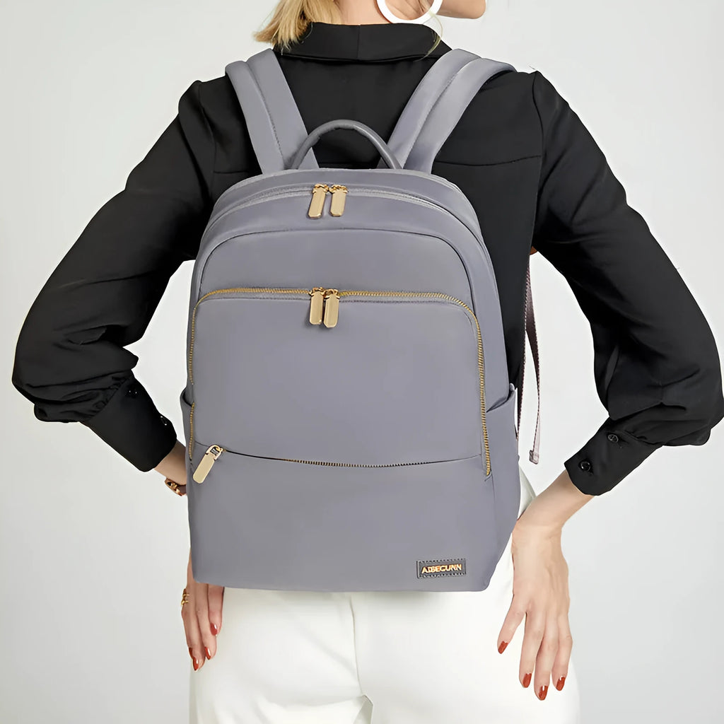 Oxford cloth women's large capacity backpack in black shown with anti-theft zip and breathable back panel.