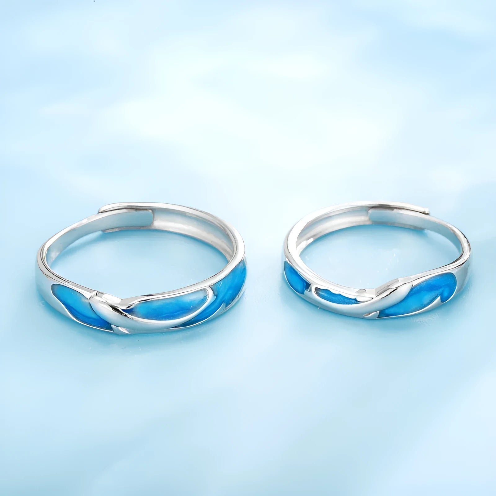 Silver adjustable couple ring with dolphin motif simple style on surface