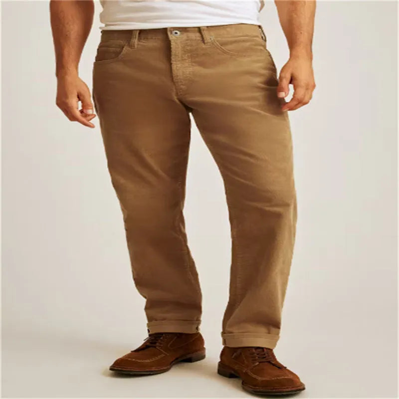Loose fit solid colour corduroy casual trousers on a hanger showing straight leg and mid waist.