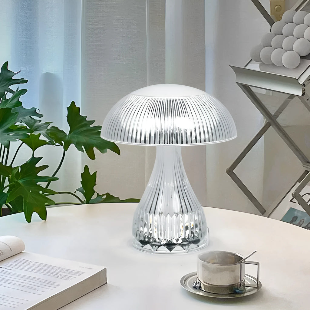 Small white rechargeable touch night lamp with three-colour changing light on wooden table