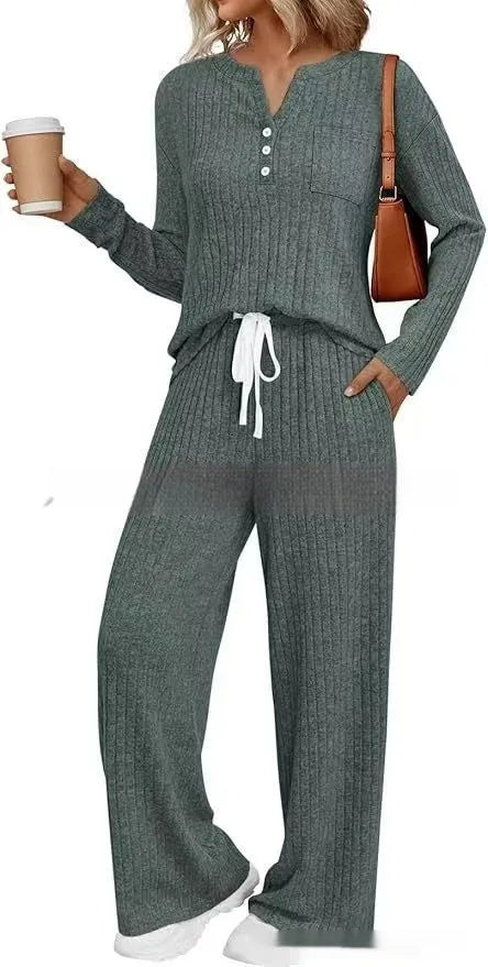 Woman wearing a striped knit V-neck long coat with lace-up details and pockets.
