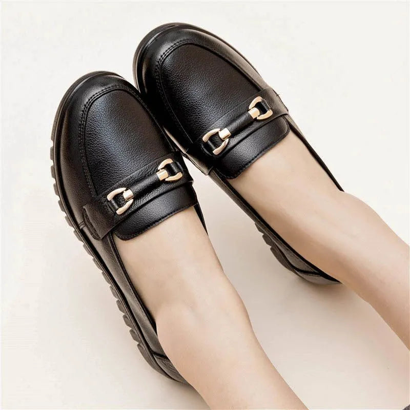 Black women's casual slip-on pumps with round toe, soft sole, and a low flat heel.