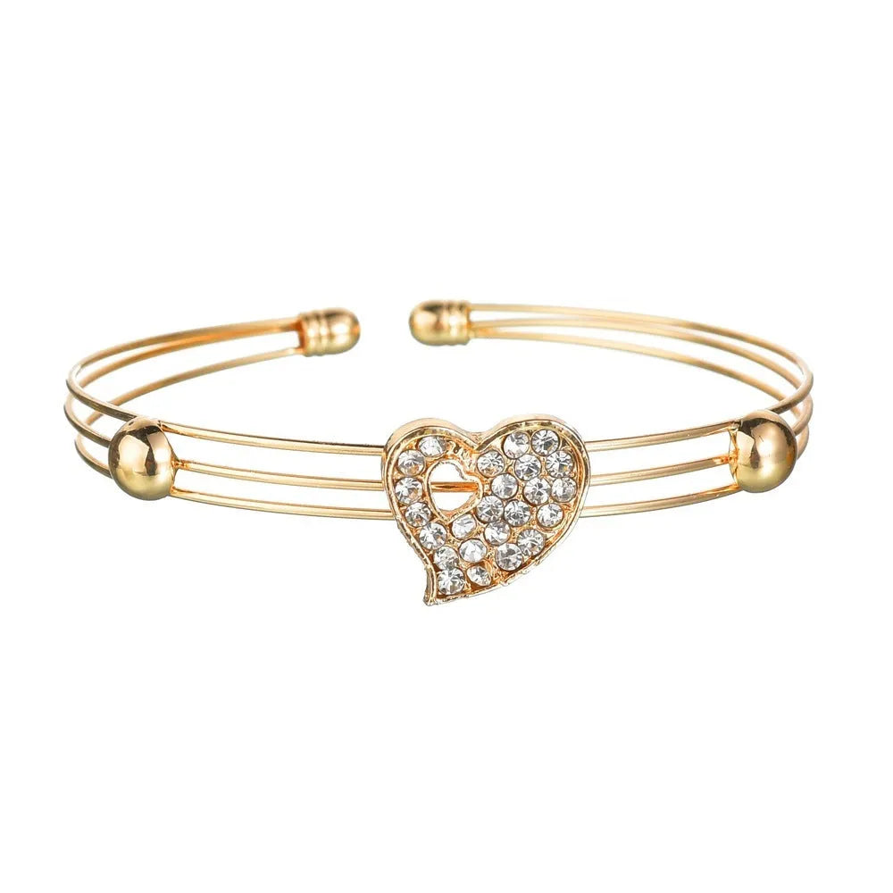 Gold electroplated alloy jewellery set with earrings, pendant, and bracelet featuring love, water drop, or bell patterns