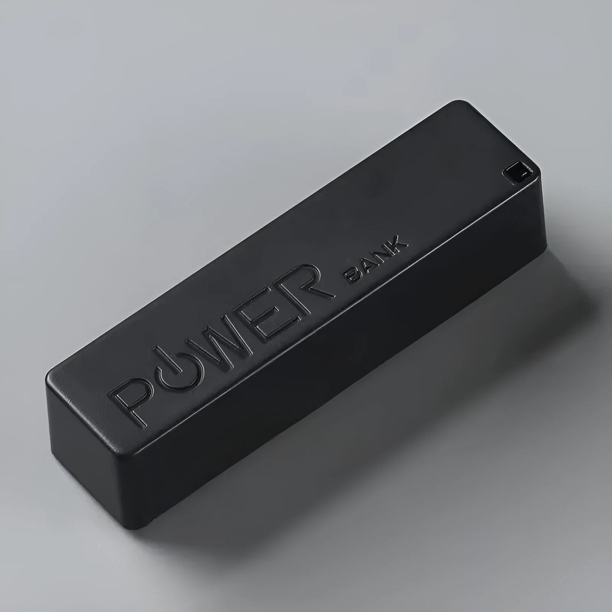 Compact white plastic power bank with wireless charging pad and built-in bracket stand