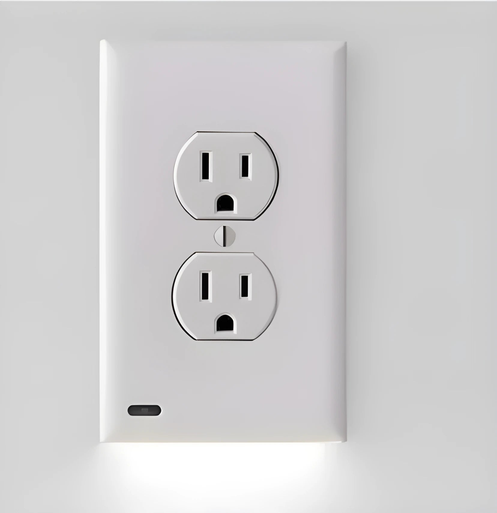 White plug-in socket induction LED night light installed on a wall outlet.