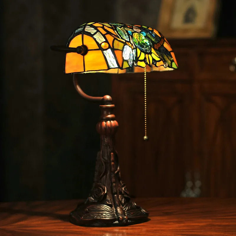 10-inch Tiffany table lamp with stained glass design and resin base on wooden desk