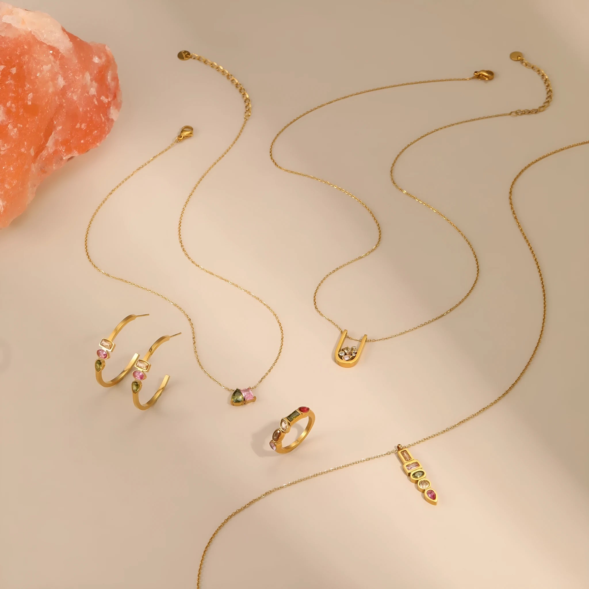 Geometric gold plated jewellery set showing necklace, ring, and earrings with zircon details on stainless steel
