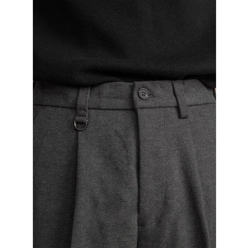 Man wearing straight-fit suit pants in a draped silhouette, suitable for business and casual occasions.