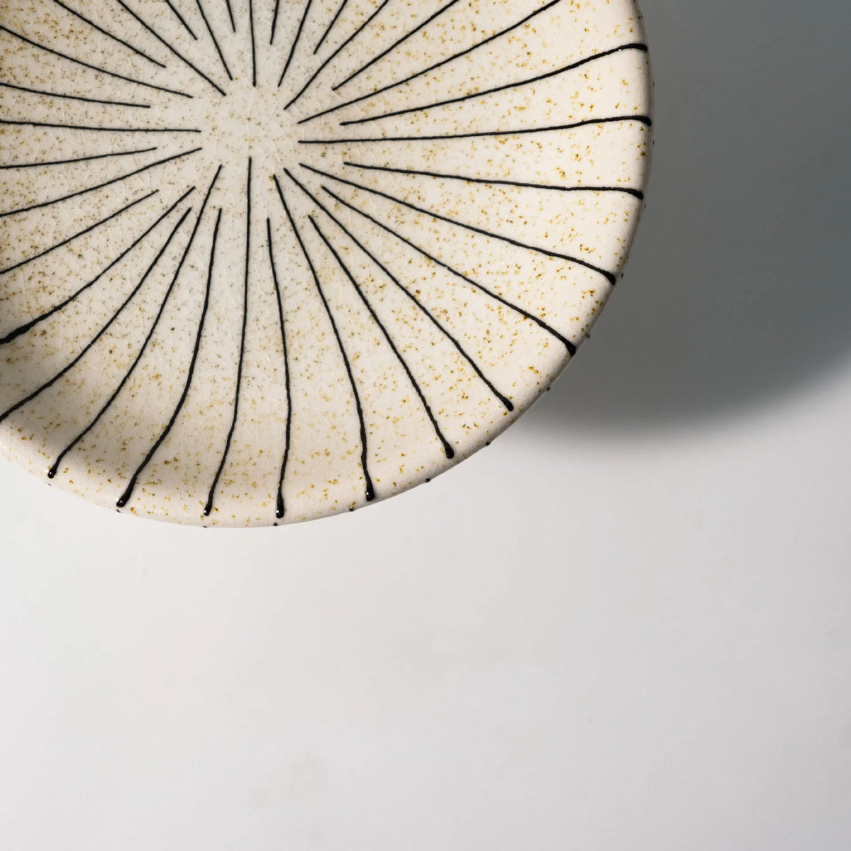 Black and white striped retro fruit plate on table with dessert