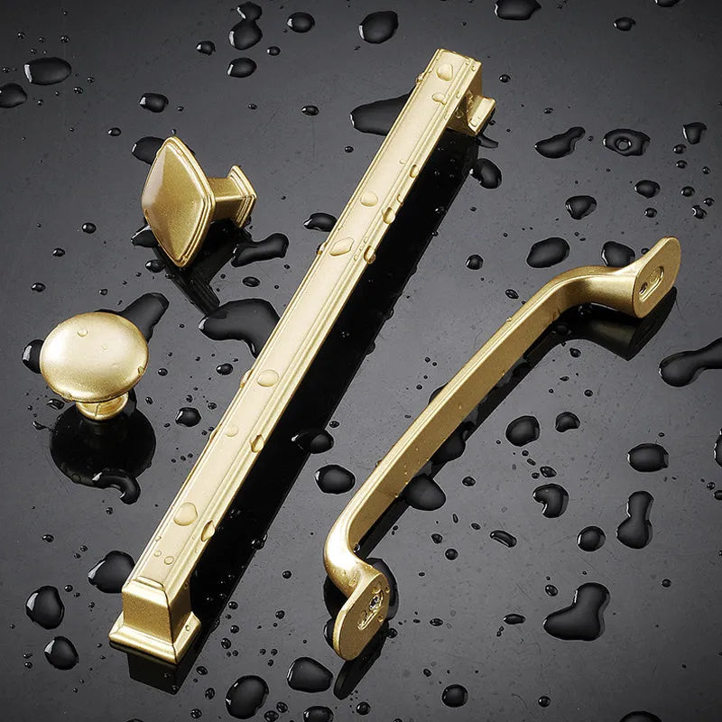 Gold coloured T-shape single hole cabinet handle made from aluminium alloy.