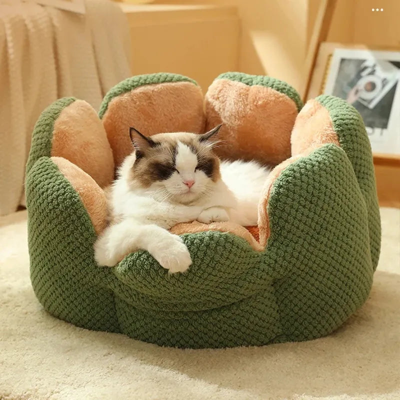 Green cactus petal-shaped soft plush pet bed for cat or dog on a hardwood floor.