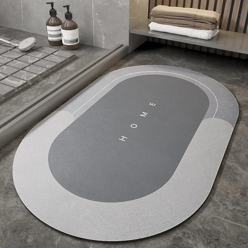 Blended fibre machine woven bathroom floor mat in blue, shown in an oval shape on a tiled floor.
