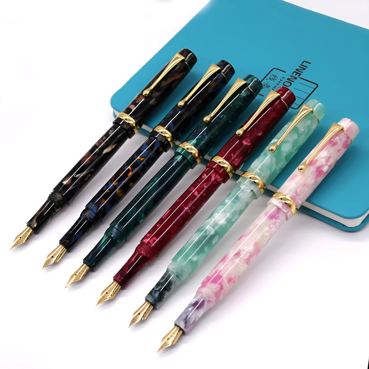 Acrylic fountain pen in multiple colours including black, blue, green, pink, and red