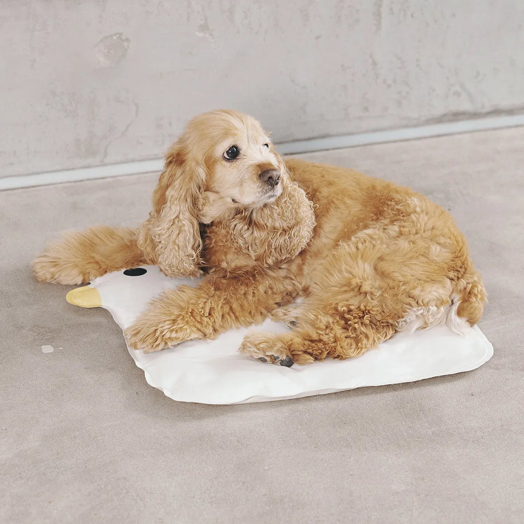 Washable chick-pattern pet cooling mat for dogs and cats on a floor