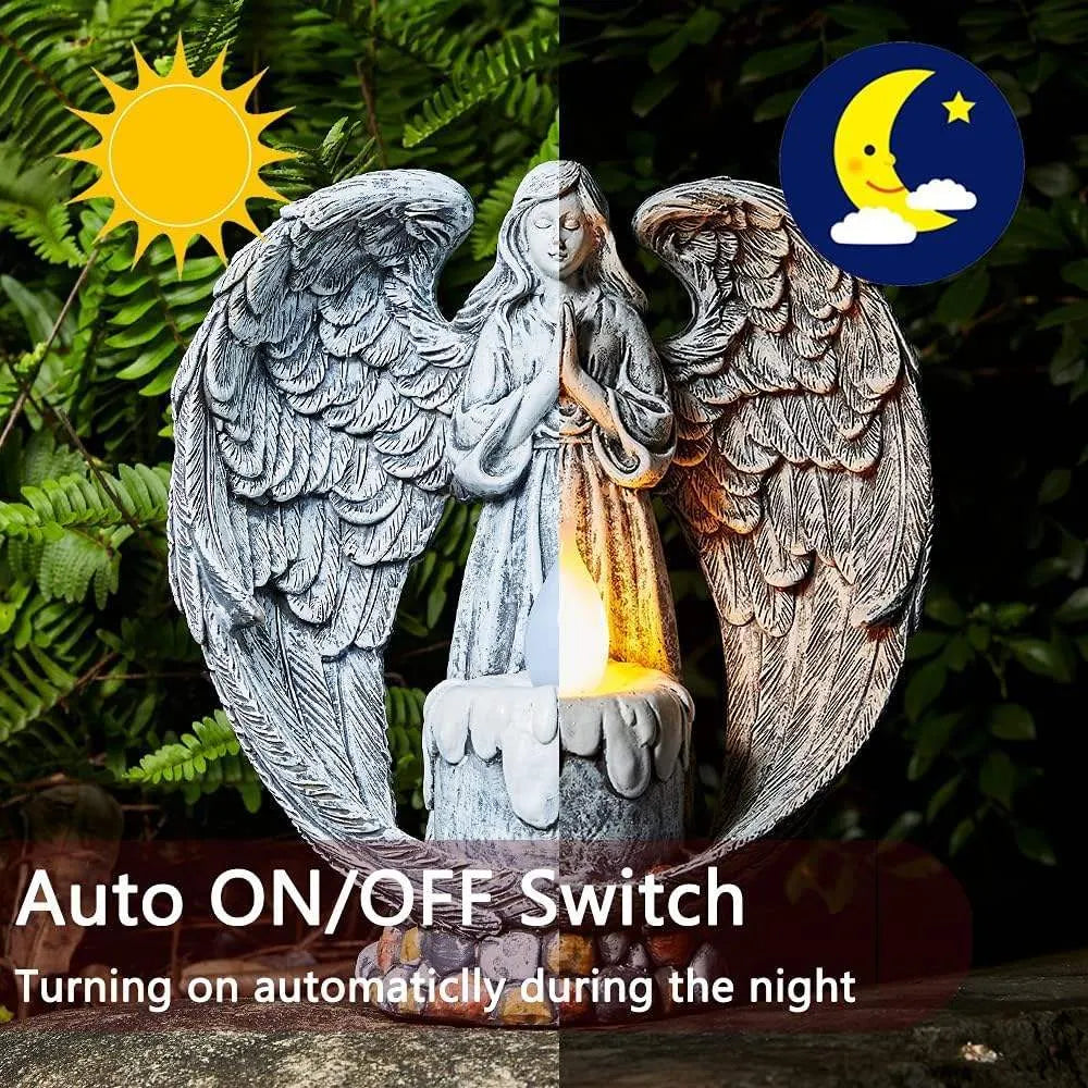 Grey resin praying angel solar garden statue on grass with wings and hands clasped
