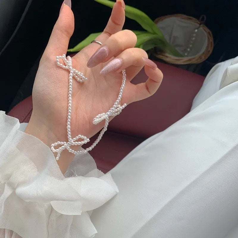 White imitation pearl necklace with bow pendant on adjustable 31-40cm chain
