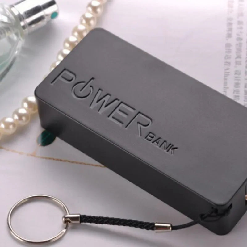Compact white plastic power bank with wireless charging pad and built-in bracket stand