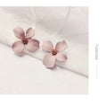 Flower design stud earrings for women in white or pink electroplated finish